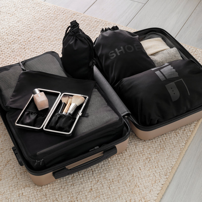 Organizer set in black with large laundry bag in a suitcase
