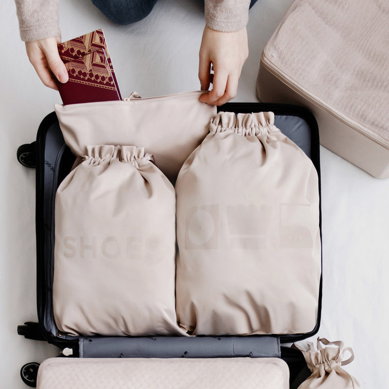 Organized laundry bag and shoe bag in beige in a suitcase