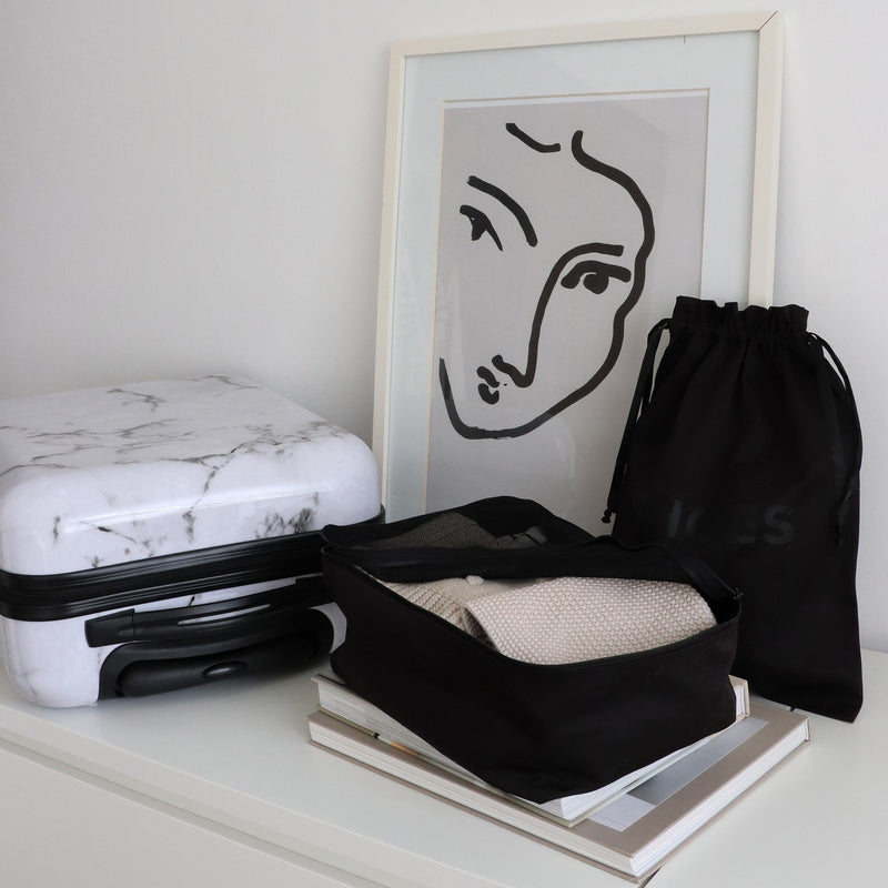black shoe bag and packing cube