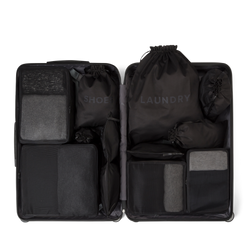 11 piece black packing organizer set in a suitcase