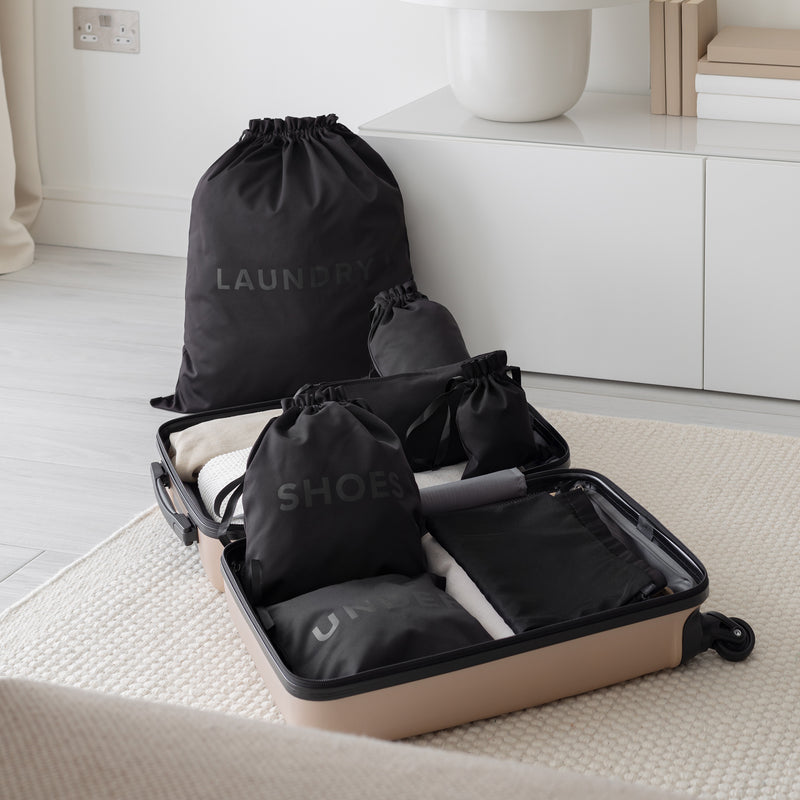 Extra large laundry bag with other packing organizers in a suitcase