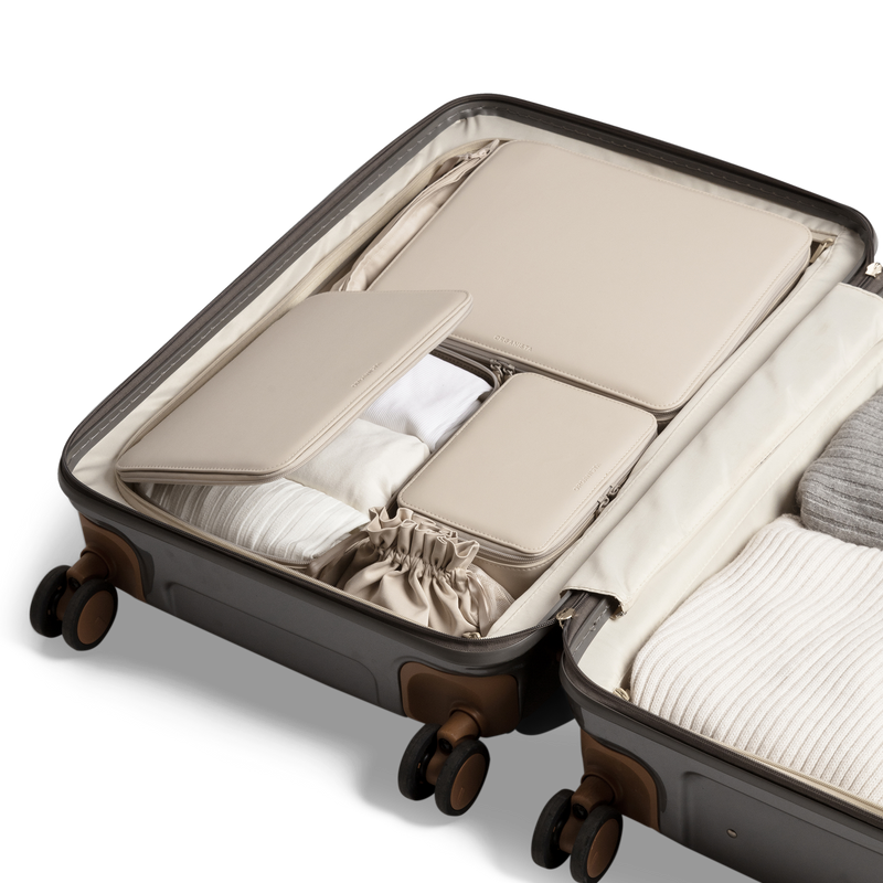 Vegan packing cube set in the color beige in a suitcase