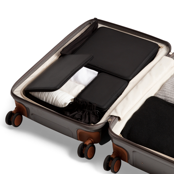 Our vegan black packing cubes in a suitcase