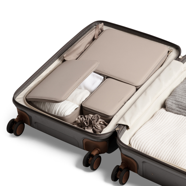 Our vegan brown packing cubes in a suitcase