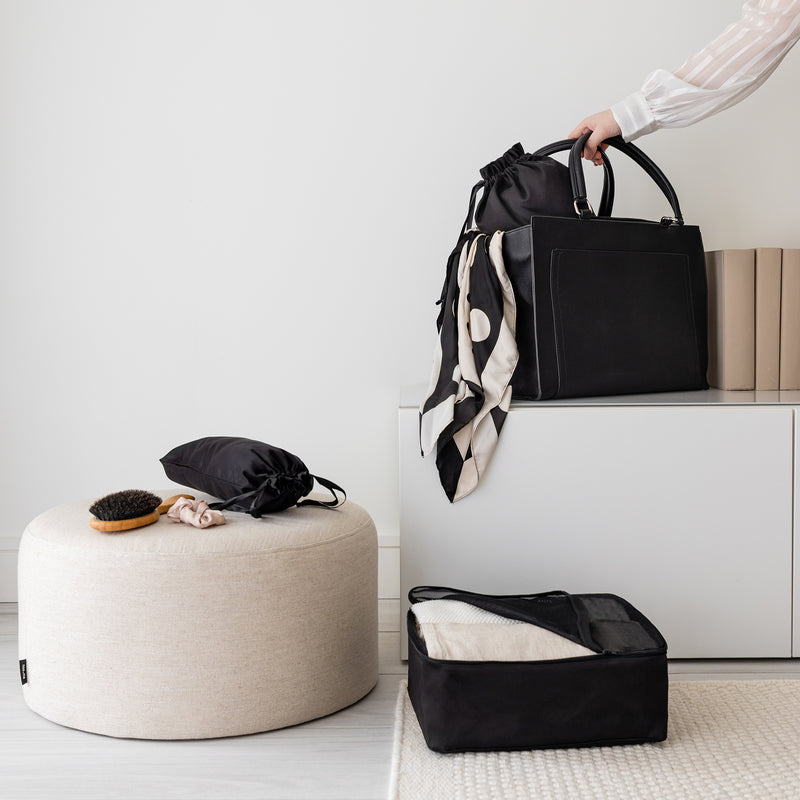 Black bag organizers in a beige and black home