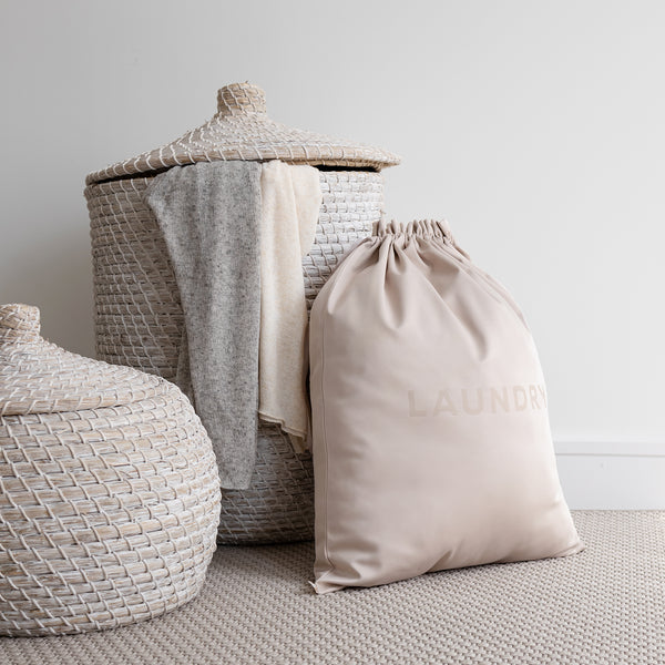 extra large laundry bag in beige in front of a basket