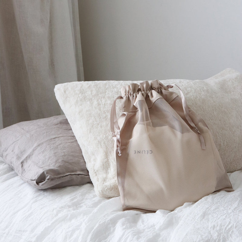 Best beige transparent bag on a bed